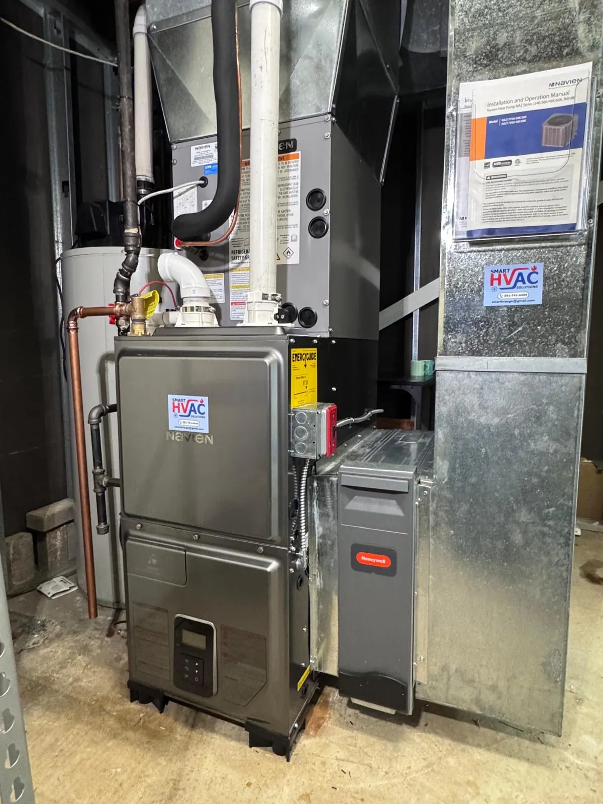 Newly installed furnace and air handler with insulated supply plenum and piping in a basement